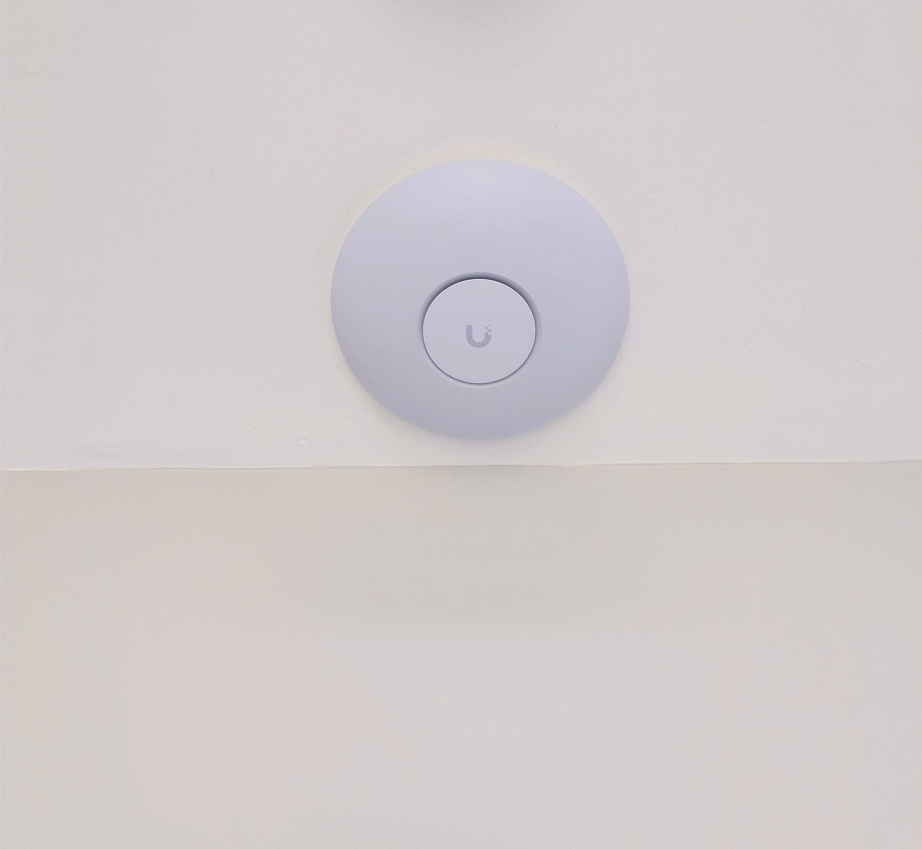 UniFi U7 Pro WiFi 7 access point ceiling-mounted in a living area