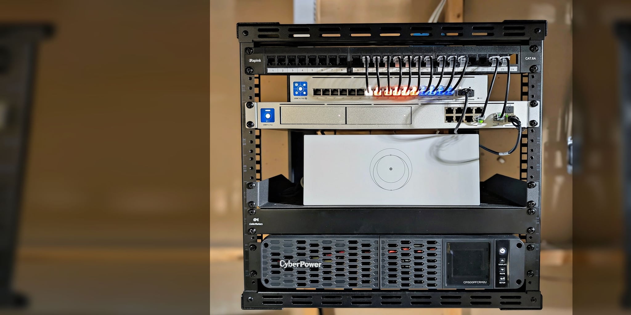 Executive network core in an open-frame rack — Cat6A patch panel, PoE switching, UDM Pro Max gateway, and rack-mount UPS