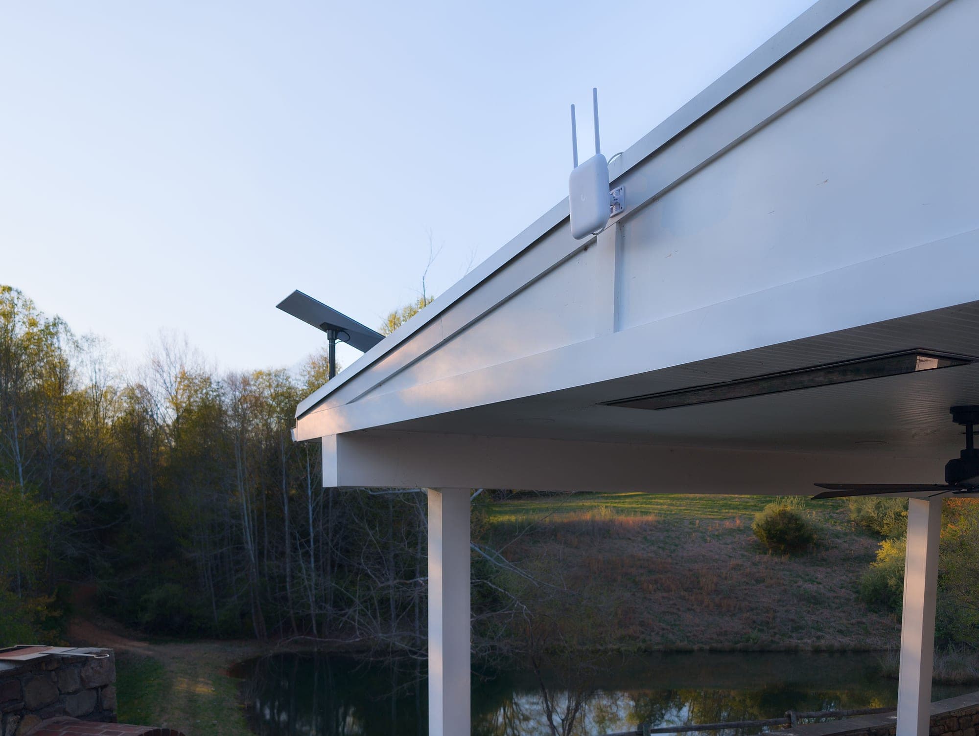 U7 Pro Outdoor under the pavilion roofline with the pond and grounds beyond