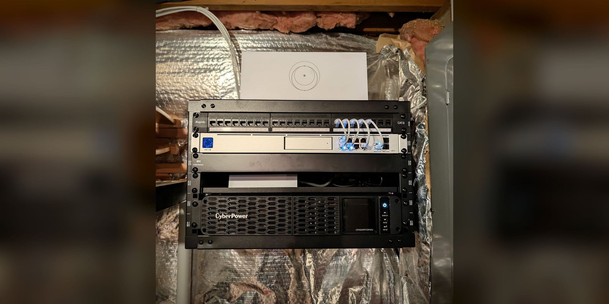 Open-frame network core in Great Falls, Virginia: UniFi Dream Machine SE, Cat6 patch panel, Starlink router, and CyberPower UPS
