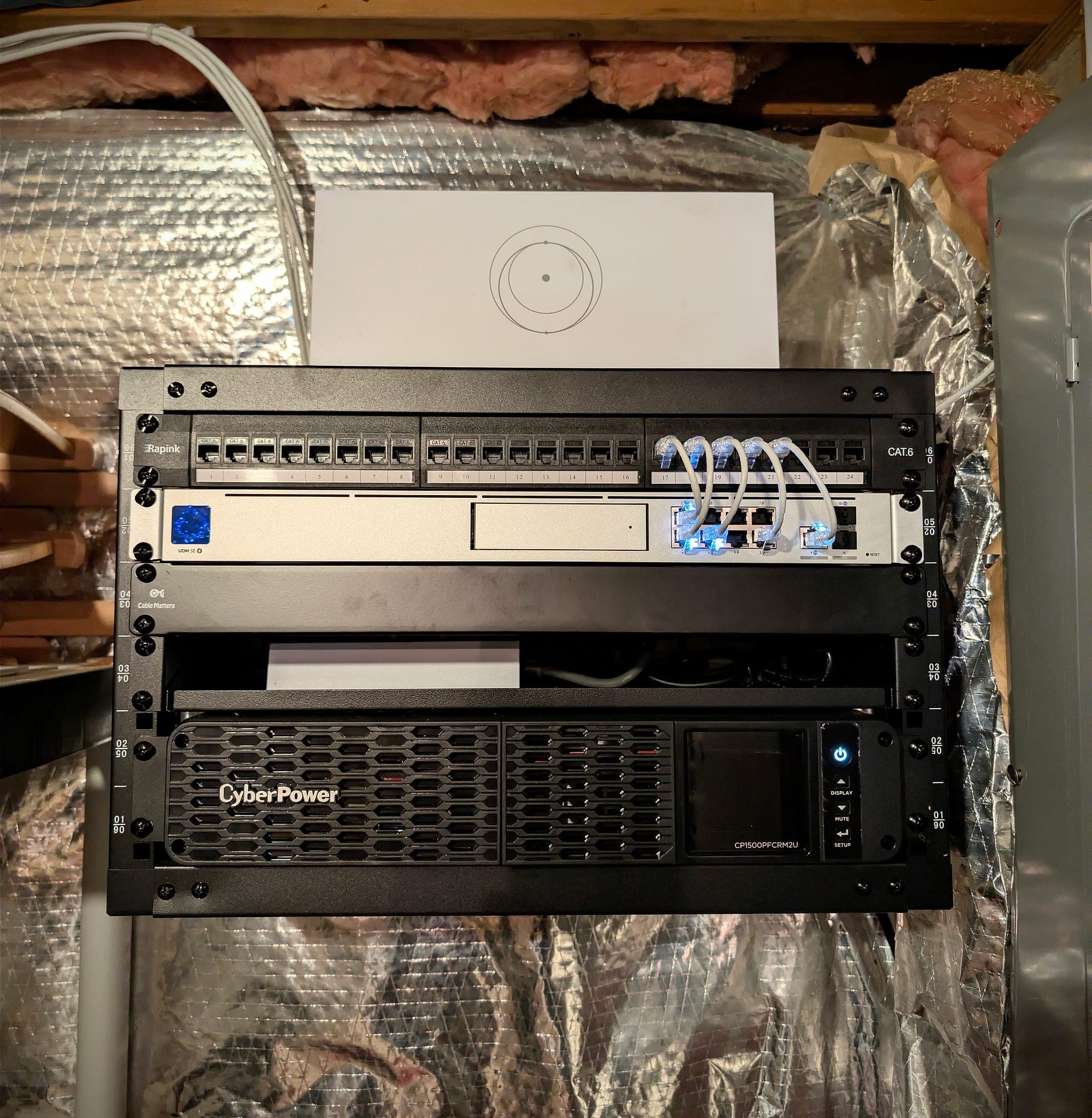 Rack detail — gateway and UPS, with patch leads dressed from the panel to the gateway’s ports