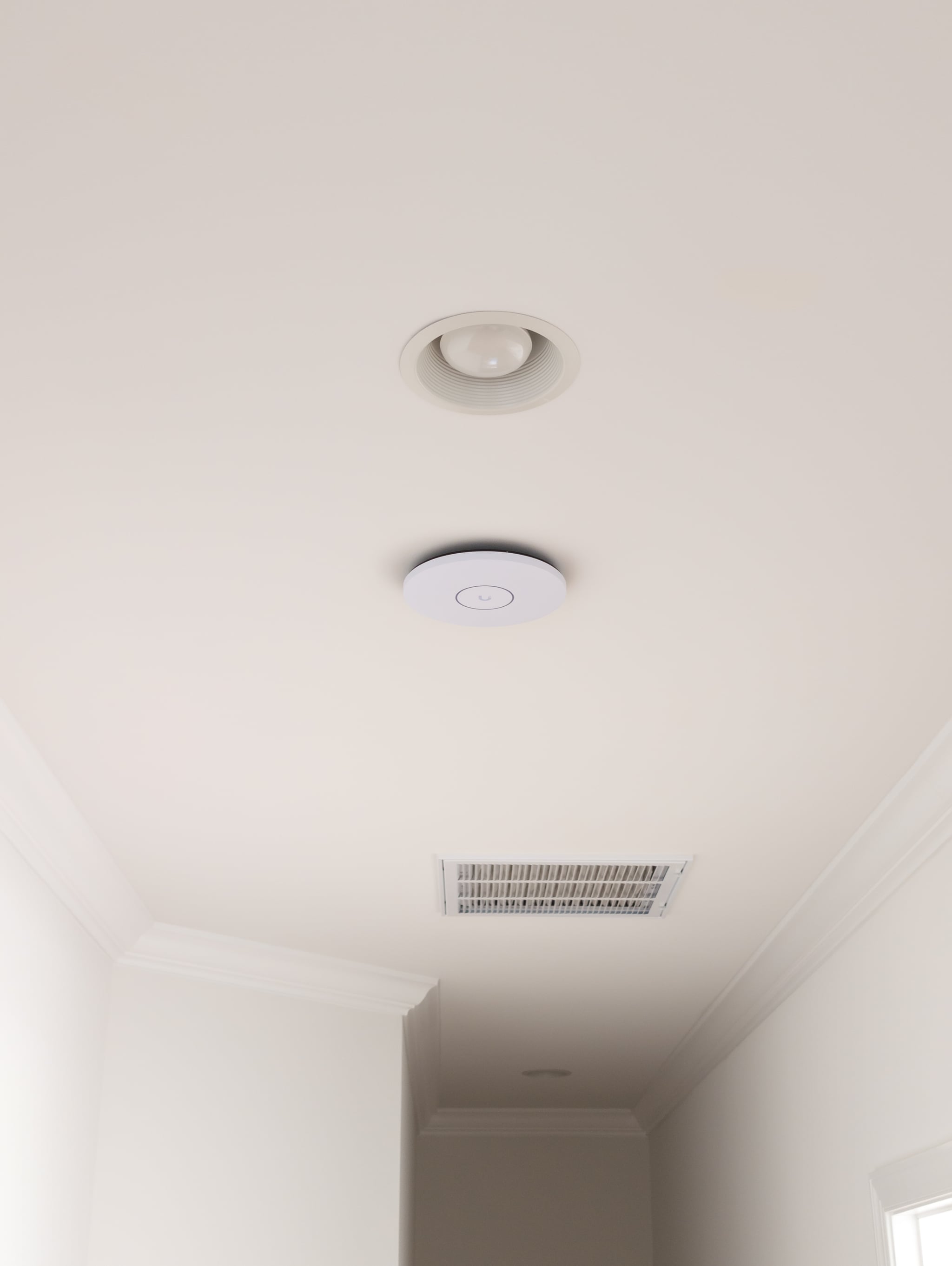 UniFi U7 Pro XGS access point ceiling-mounted in a Northern Virginia new construction estate