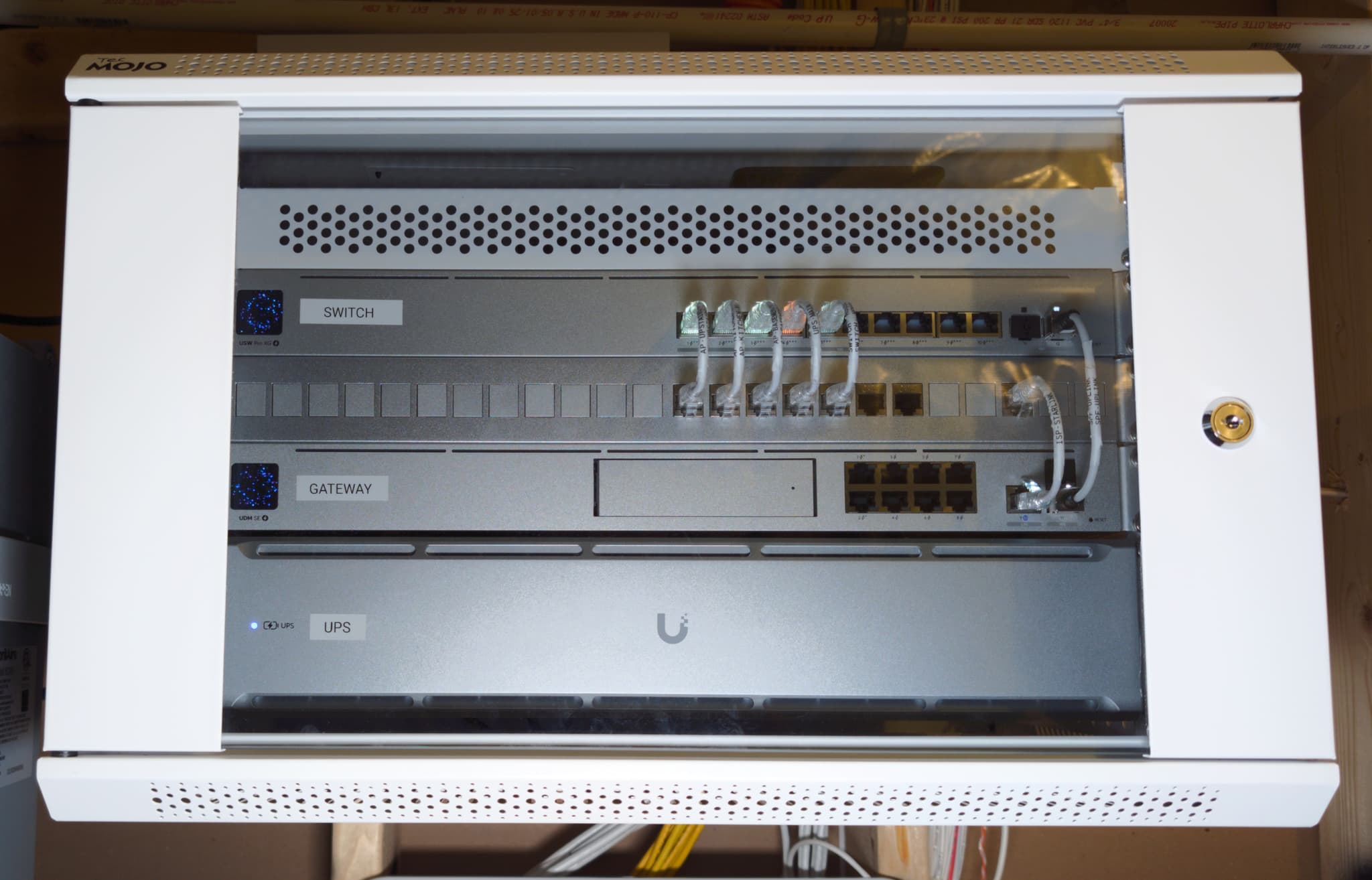 Equipment rack at a Leesburg executive residence — UDM SE gateway, USW Pro XG switch, and rack UPS, each bay labelled and every port terminated