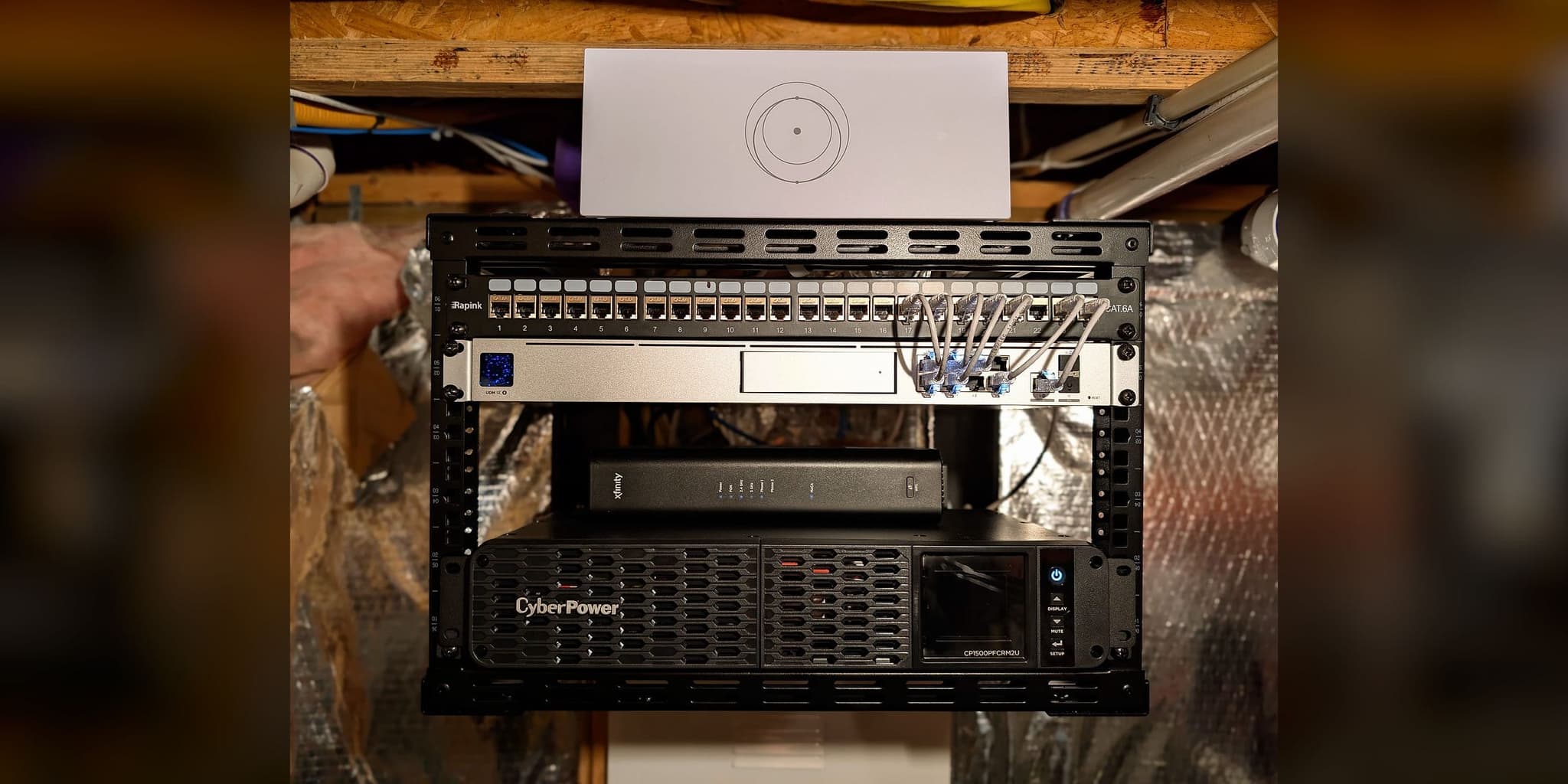 Executive dual-WAN failover core in Leesburg, Virginia — UniFi Dream Machine SE, PoE switch, Starlink router, and CyberPower UPS on an open-frame rack