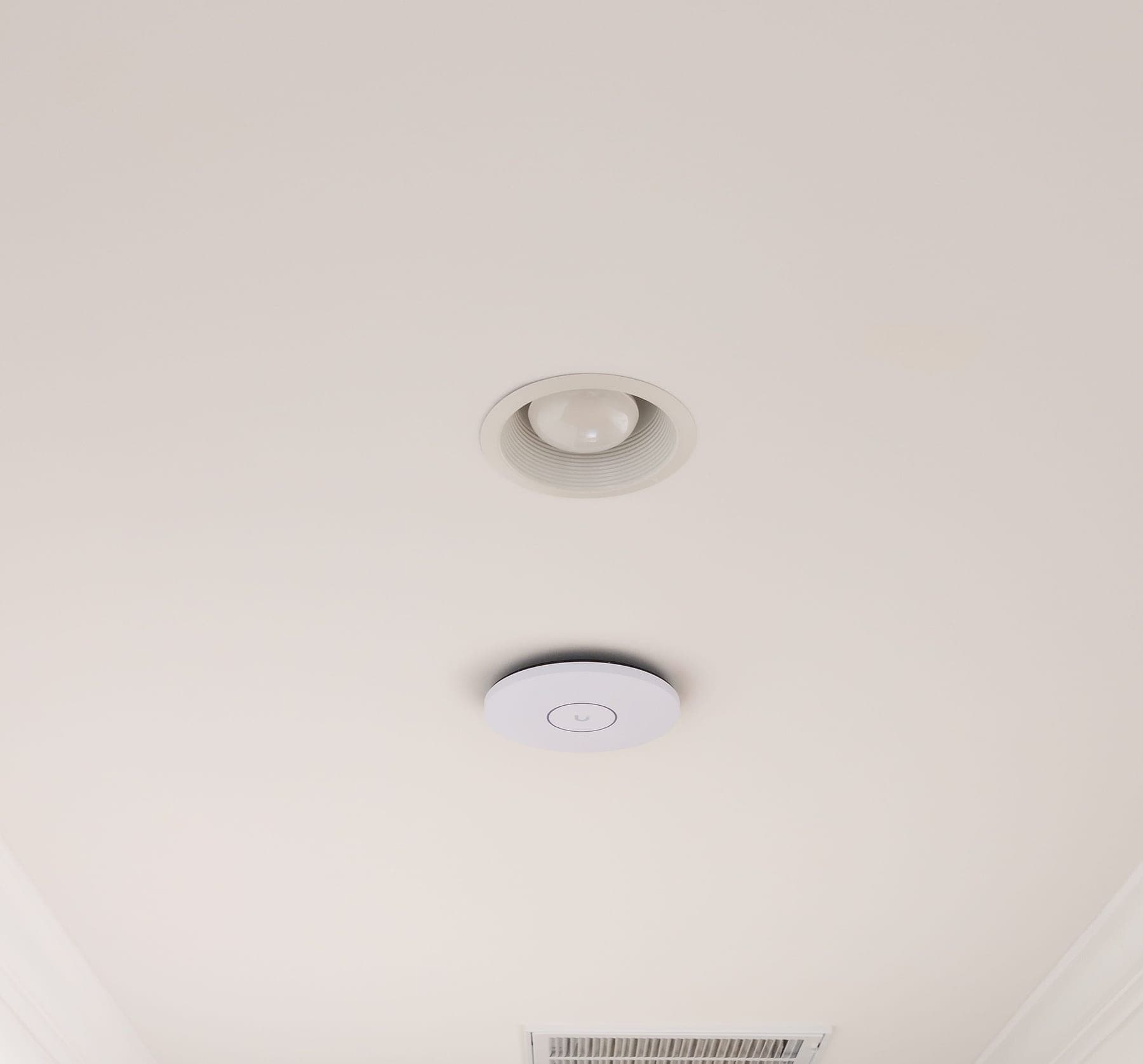 UniFi U7 Pro XGS ceiling-mounted in the upstairs hallway