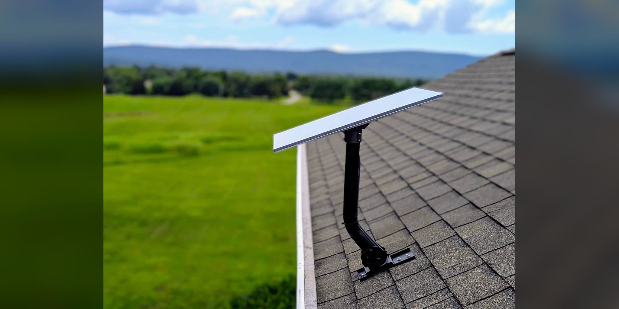 Starlink dish on a roof mount with open fields and the Blue Ridge beyond