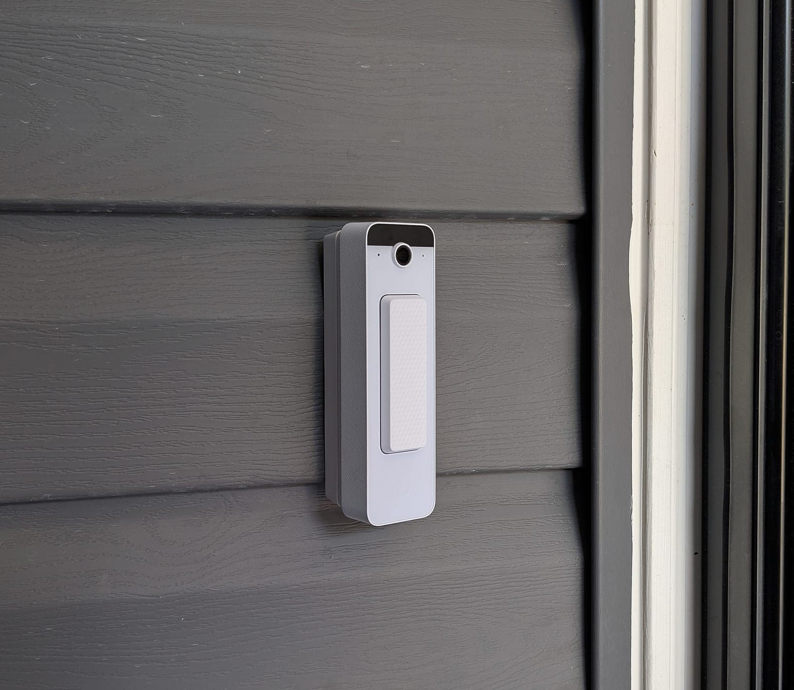 UniFi Doorbell Lite mounted on siding beside the front entry